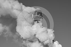 Black and white photo of  chimney and smoke