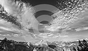Black and white photo of cloudscape over Half Dome in Yosemite N