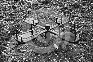 black and white photo of detail of playground during winter season