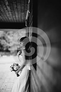 Black and white photo. elegant bride in white dress posing. Bride portrait wedding