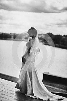 Black and white photo. elegant bride in white dress posing. Bride portrait wedding