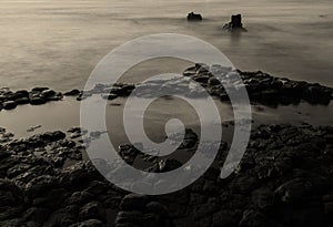 Black and white photo exposes marine landscape at lava rapids created by ancient volcanoes