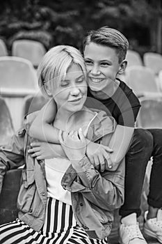 black and white photo of happy mother and son hugging while sitting
