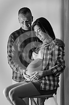 Black and white photo of heterosexual couple waiting for a baby