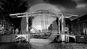 Black and White photo of a Historic Draw Bridge over the Nieuwe Herengracht at the Amstel Canal in the old city of Amsterdam