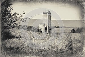 Black and white photo of a landscape with a silo and barn near Rectortown Virginia in Fauquier County.