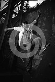 Black and White Photo of a man climbing a wall