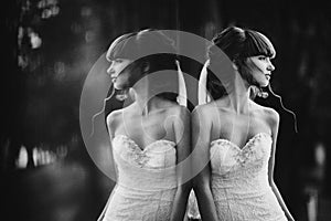 Black and white photo with the noise of a beautiful cheerful young bride in a luxury white dress. displaying the bride in the