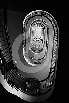 Black and white photo of old spiral staircase, spiral stairway inside old house in Budapest, Hungary