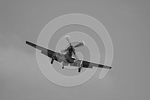 Black and white photo of a P51 MUSTANG 413779 on finals at EMA - stock photo photo