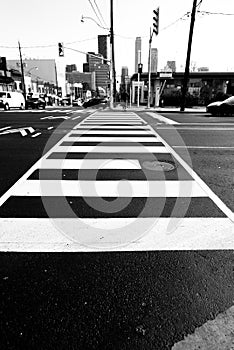 black and white photo of pedestrian crosswalk at city road