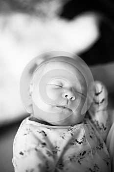 Black and white photo in retro style.a pretty sleeping newborn baby