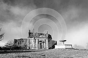 Black and white phoo of ruins of ancient catholic church in an italian rural area