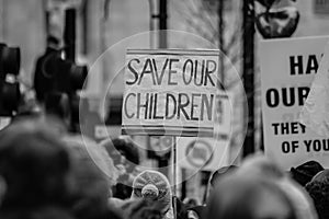 Black and white photo of a SAVE OUR CHILDREN placard
