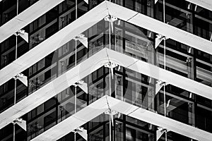 Black and white photo showing architectural details of building with lots of horizontal lines, glazing and diagonal lines