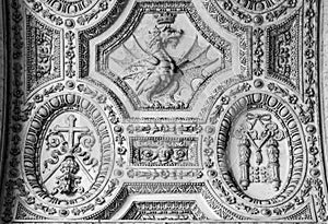 Black and white photo showing close-up on crowned dragon symbol, carved on marble wall inside church in the Vatican