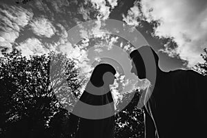 Black and white photo. silhouette of Loving young couple is having fun outdoors. Love and tenderness, dating, romance, family