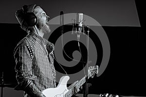 Black and white photo of singing guitarist