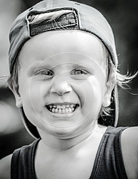 Black and white photo of a smiling boy