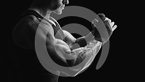 Black and white photo of strong hands and fist, ready for training and active exercise Strong man wrap hands Man is wrapping hand