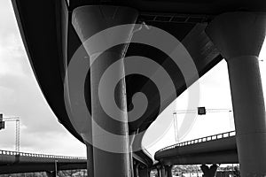 Black and white photo of tall road viaducts..