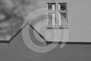 a black and white photo of two windows on a building