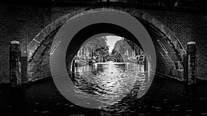 Black and White photo of View of seven historic bridges in a straight line over the Reguliersgracht in Amsterdam