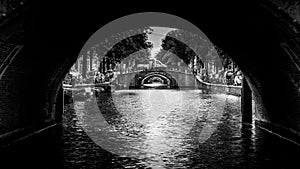 Black and White photo of View of seven historic bridges in a straight line over the Reguliersgracht in Amsterdam