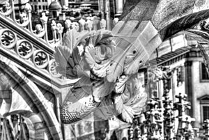 Black and white photo of the white marble statues, spires and stone sculptures on the roof of famous Cathedral Duomo