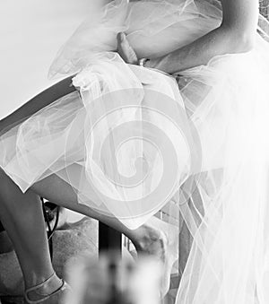 Black and white photo of a woman getting ready for a wedding ceremony