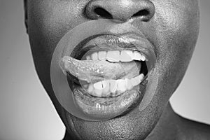 Black and white photo of woman sticking out tongue