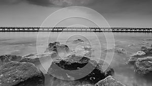 Black and white photo of the wooden bridge along the beach, Bangkok Thailand