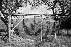 Black and white photo of a wooden canopy for hay. Atmospheric photography