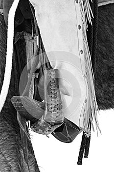 Black and white photograph of cowboy boots and spurs