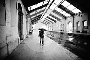 black and white photograph of a deactivated train station in the city of Barreiro on a rainy day.