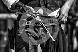 Black and White Photograph of Gunfighter and colt revolver