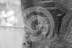 Black and white photograph of light and shadow on a stucco artwork of an angel