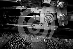 black and white photograph of a train wheel and its hubs