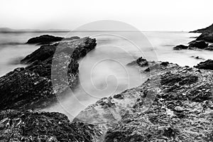 Black and white photographs of rocks with a movement wave like mist