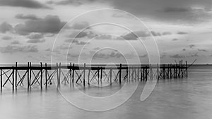 Black and white photography of a beach wooden pier