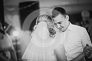 Black white photography beautiful touching first dance of the bride and groom