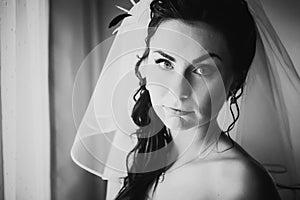 Black white photography beautiful young bride costs about stylish window
