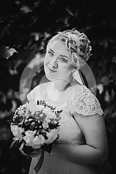 Black white photography beautiful young bride stand on background forest