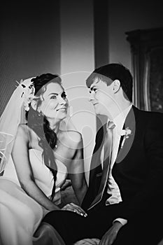 Black white photography beautiful young couple sitting on the bed