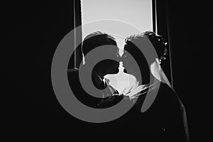 Black white photography beautiful young couple stand on a dark background