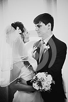 Black white photography beautiful young couple standing near the window