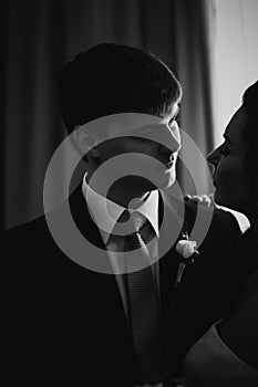 Black white photography beautiful young couple standing near the window