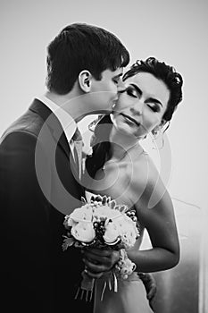 Black white photography beautiful young couple standing near the window