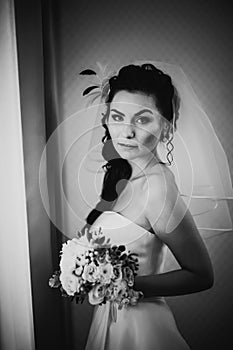 Black white photography beautiful young happy bride standing near the window