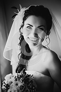 Black white photography beautiful young happy bride standing near the window